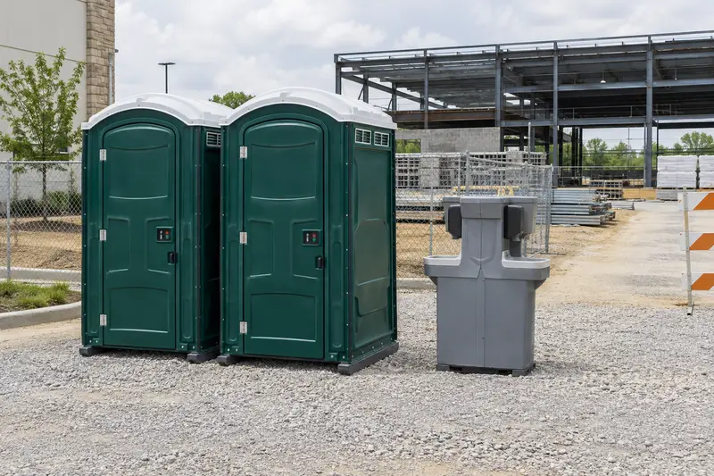 Portable toilets and washing facilities beside a construction project